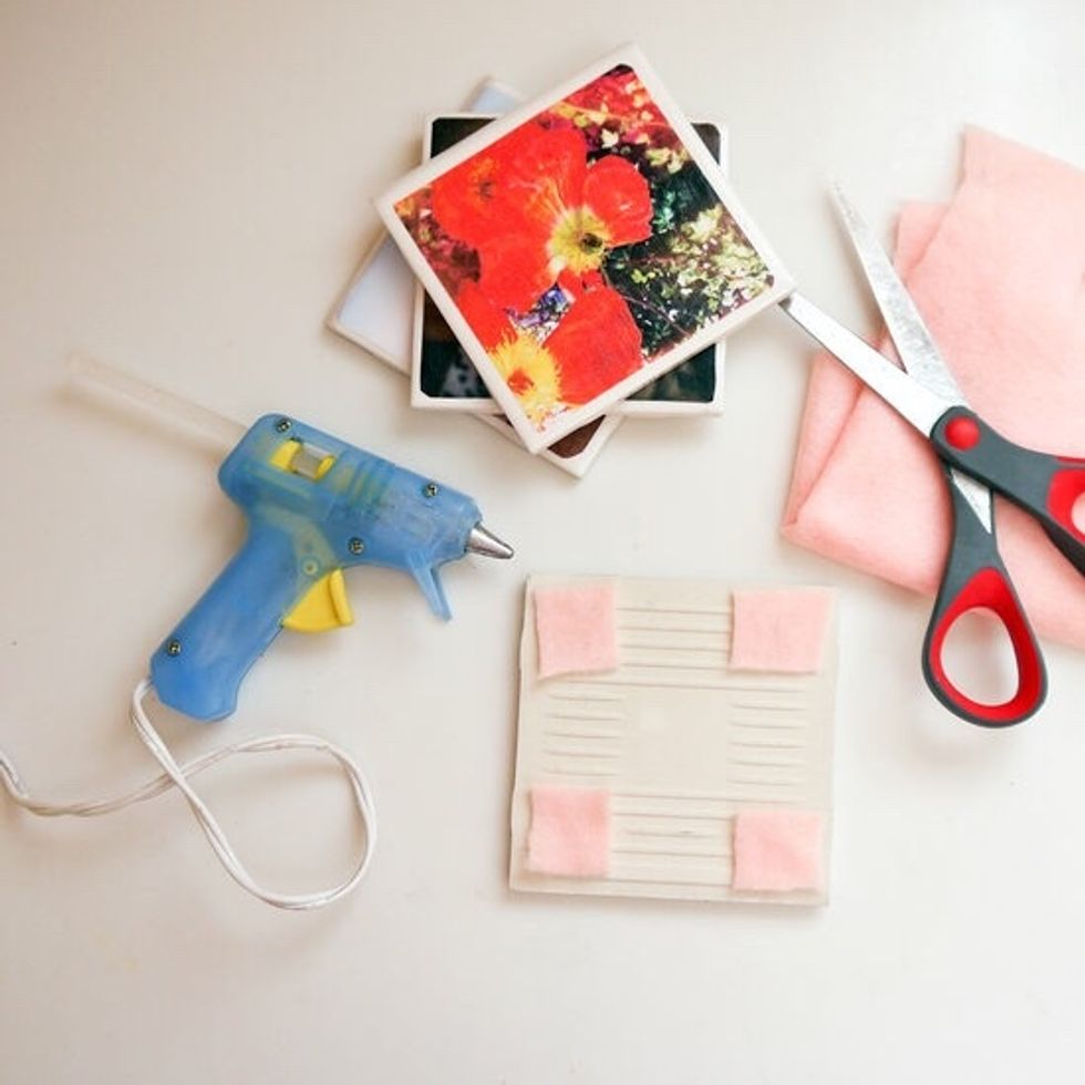Cut four small felt squares and hot glue one square of felt to each corner of the tile. Give the dry photo coasters a quick coat of clear spray sealant, which will moisture-proof the finished project.