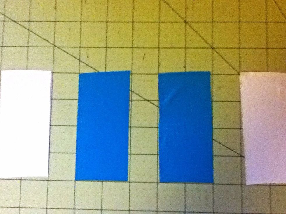 Cut four strips of duct tape. Two for each color. 4 in. each.