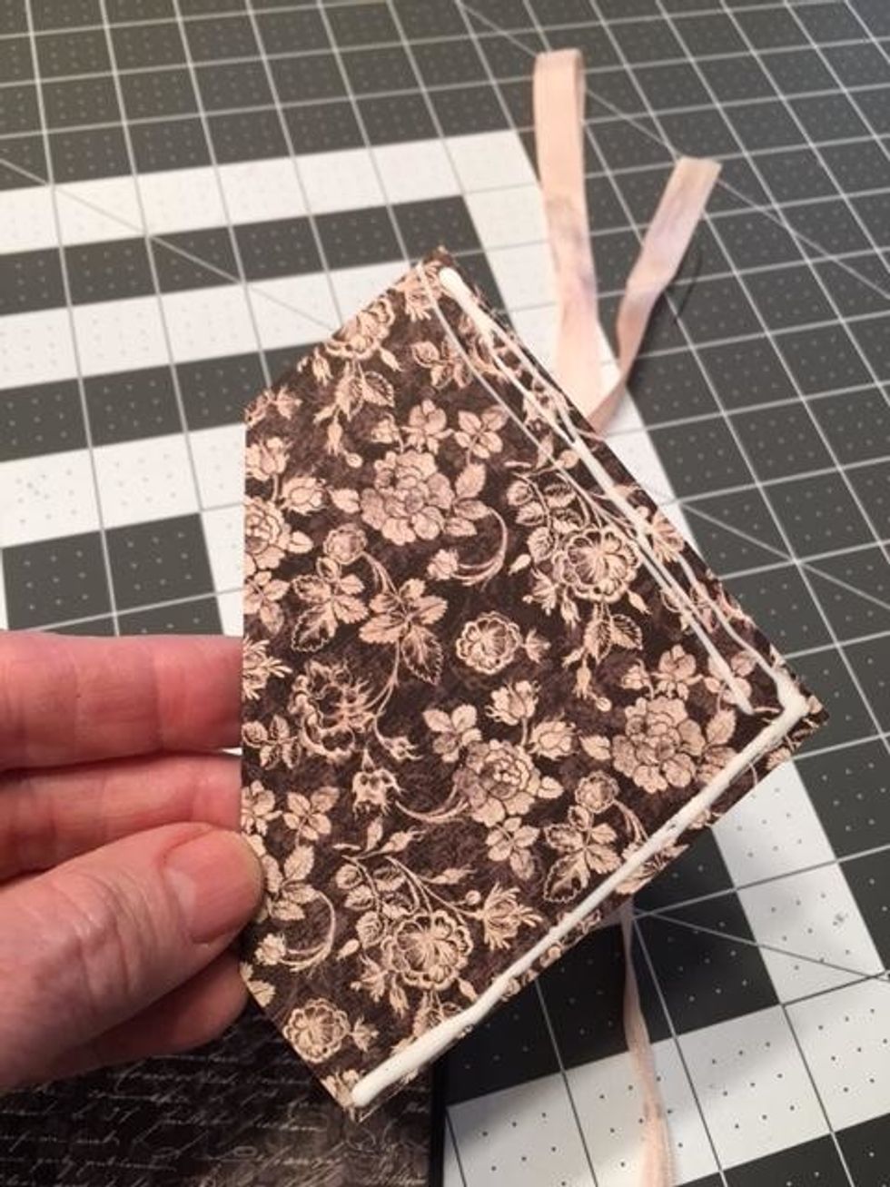 Cut from Precious One 1@ 3 3/4" wide x 3 3/4" tall.  Ink the edges.  Apply glue to the right and bottom edge only, fold the left upper corner toward the front to create an angle pocket. Glue down.