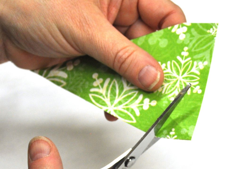 Cut from the four inch mark to the bottom centre fold on each side.