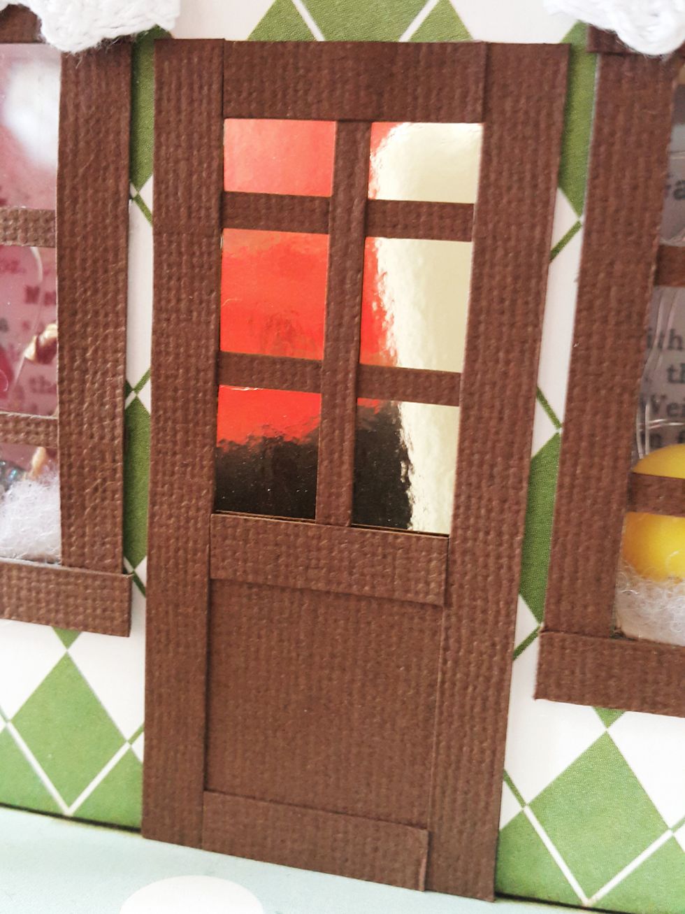 Cut gold cardstock of 1-3/8"x2-7/8" for the door, frame it with brown cardstock.