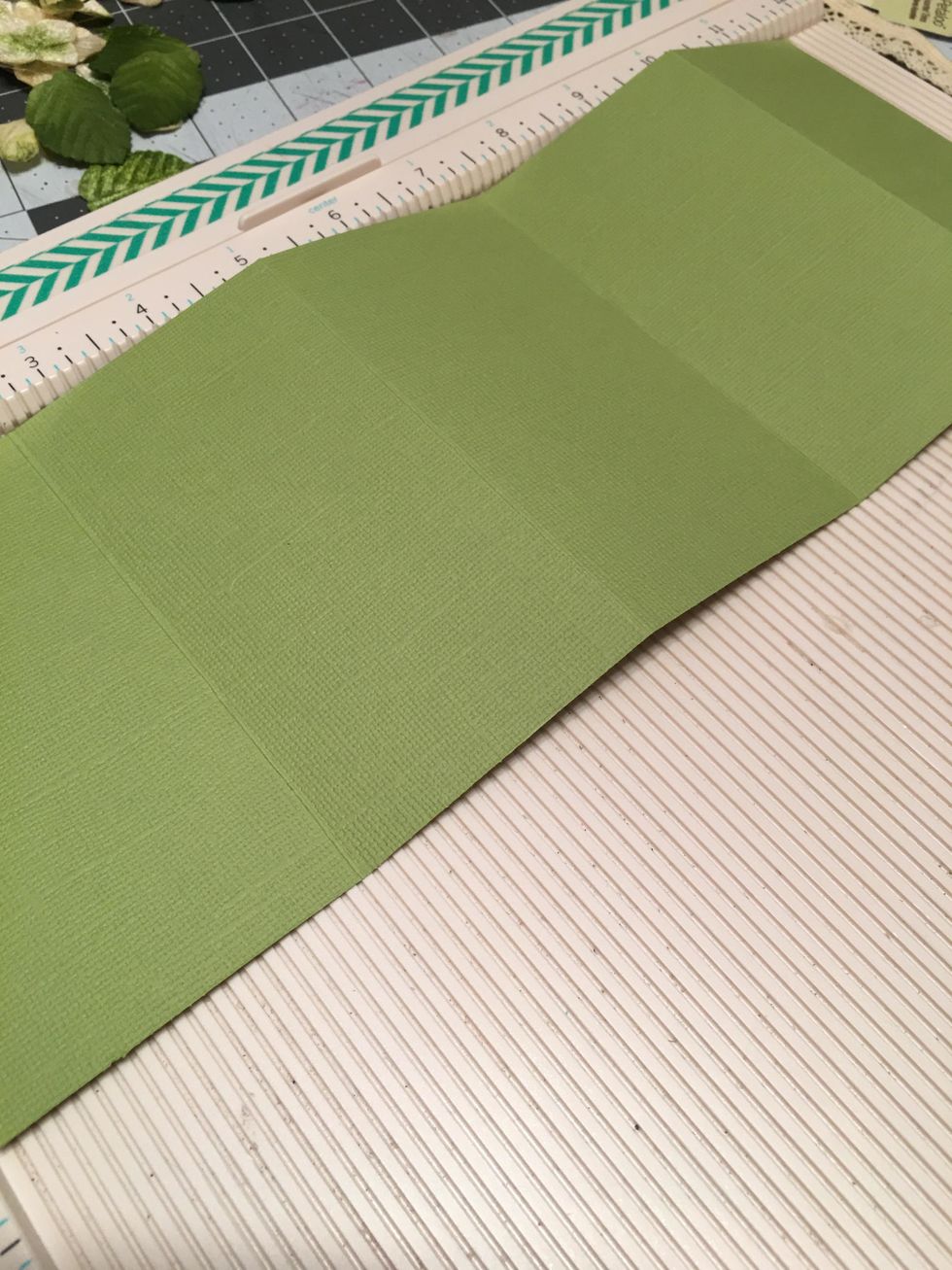 Cut Green Cardstock to 4.75" tall x 12" wide and score the 12" side at 2.5", 5", 7.5" and 10". Also cut one piece of green cardstock to 4.75" tall x 2.5" wide.