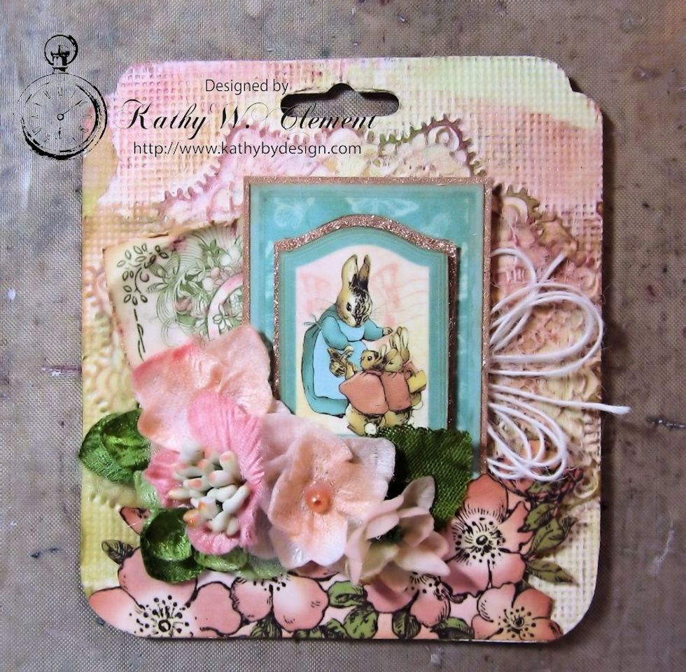 Cut green hydrangea petals in half to use as leaves and glue beneath the flower petals. Make a string bow and tuck under the image, using scissor points.