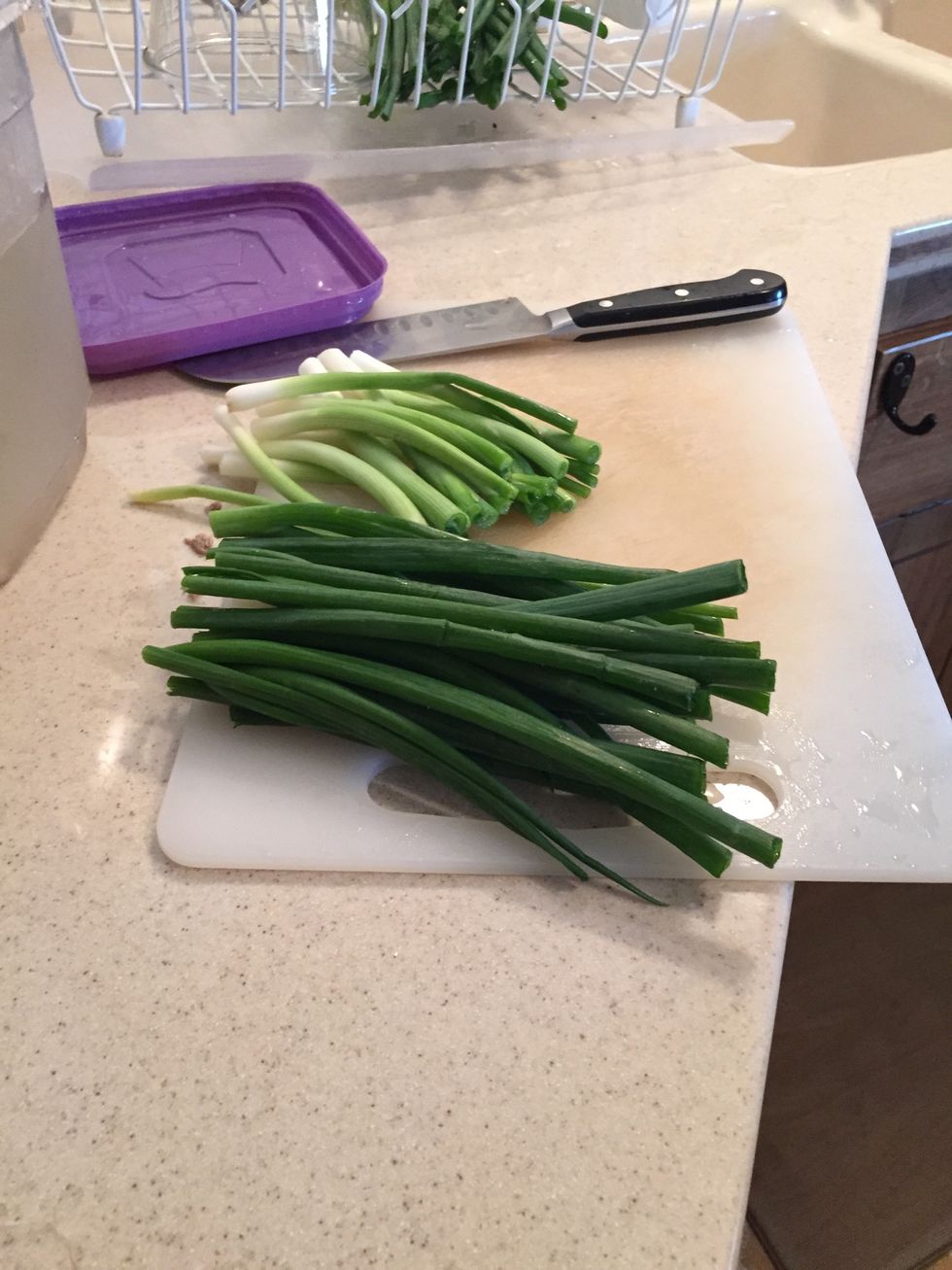 Cut green onions in half, then slice bottom in half