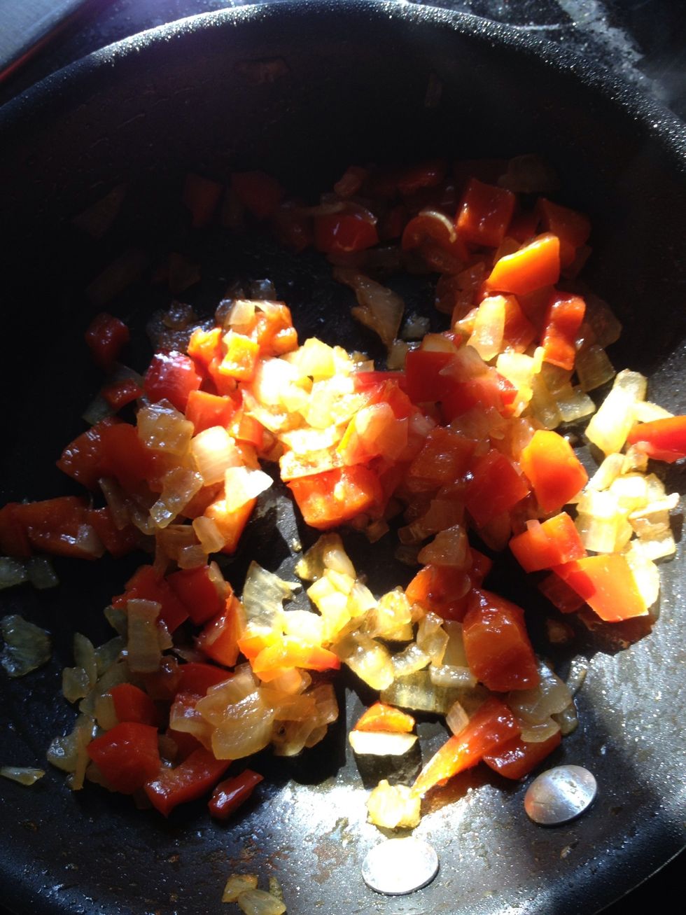 Cut half cup onions and red peppers in dices , and put in pan with oil. add 1 tsp salt and pinch of turmeric