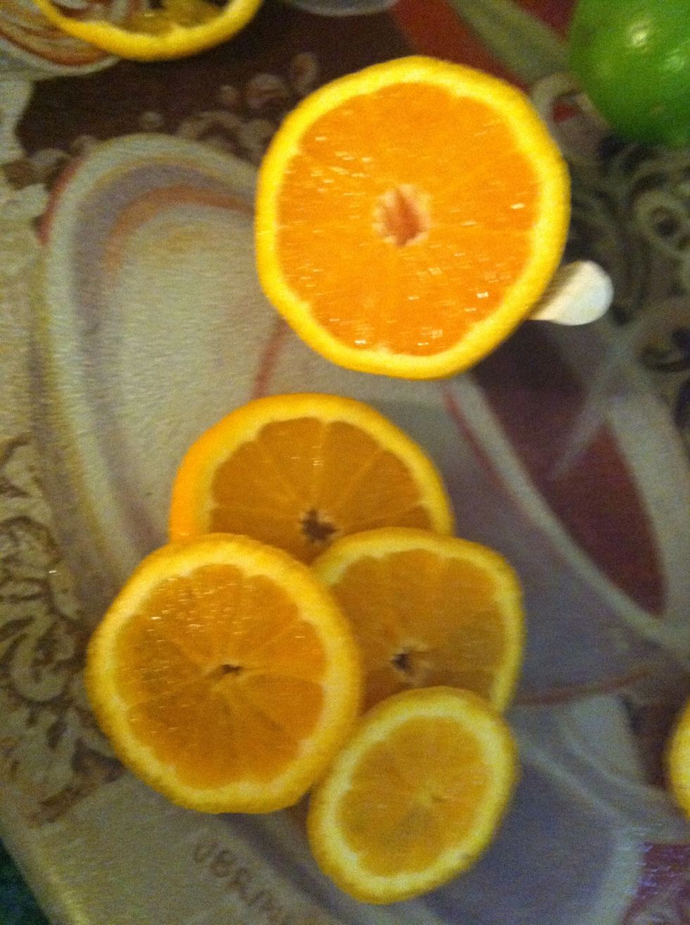 Cut half of the oranges into nice slices to be places into the pitcher