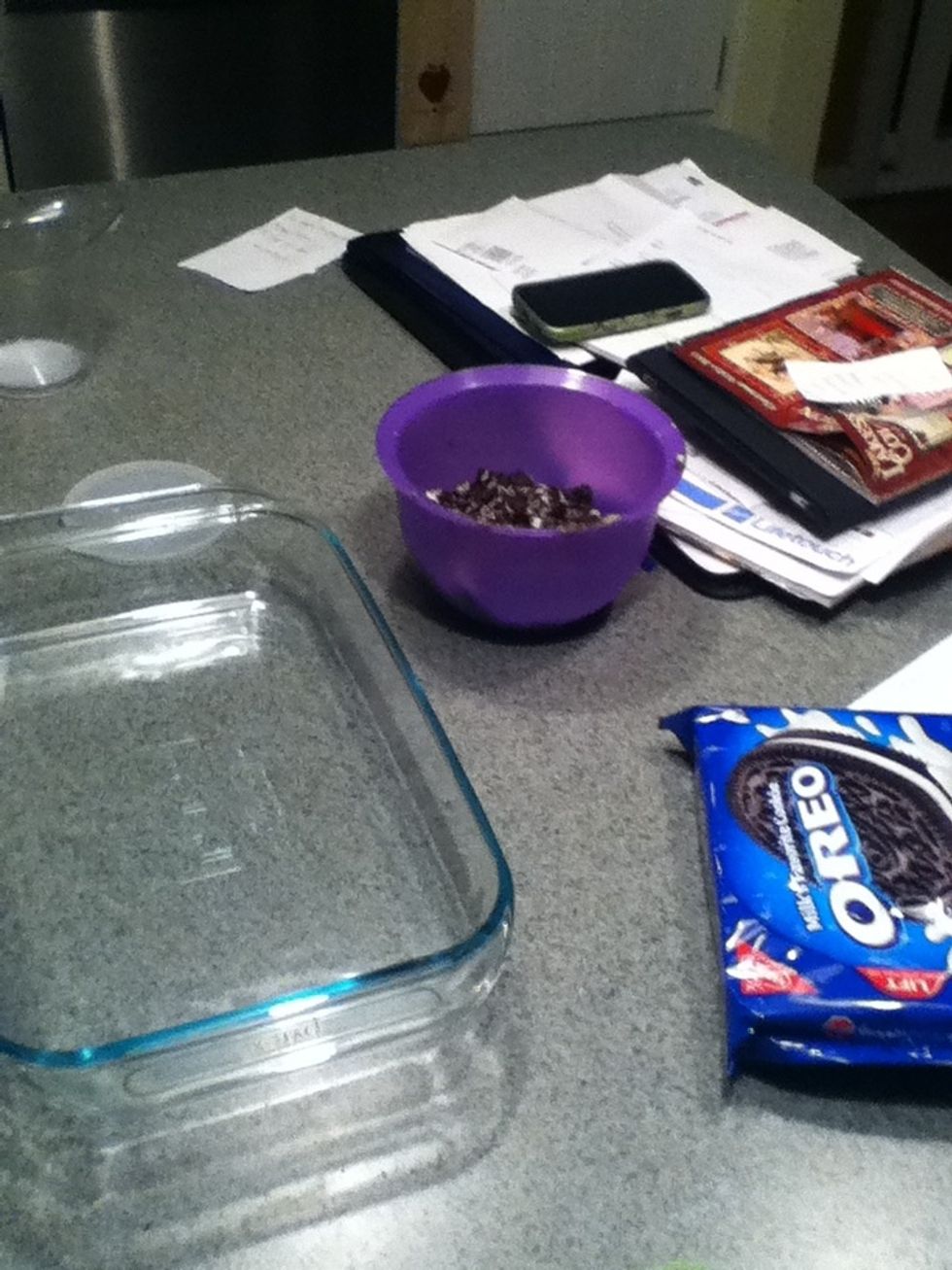 Cut half the box of oreos put them in a bowl. Then cit the other half and out that in the pan