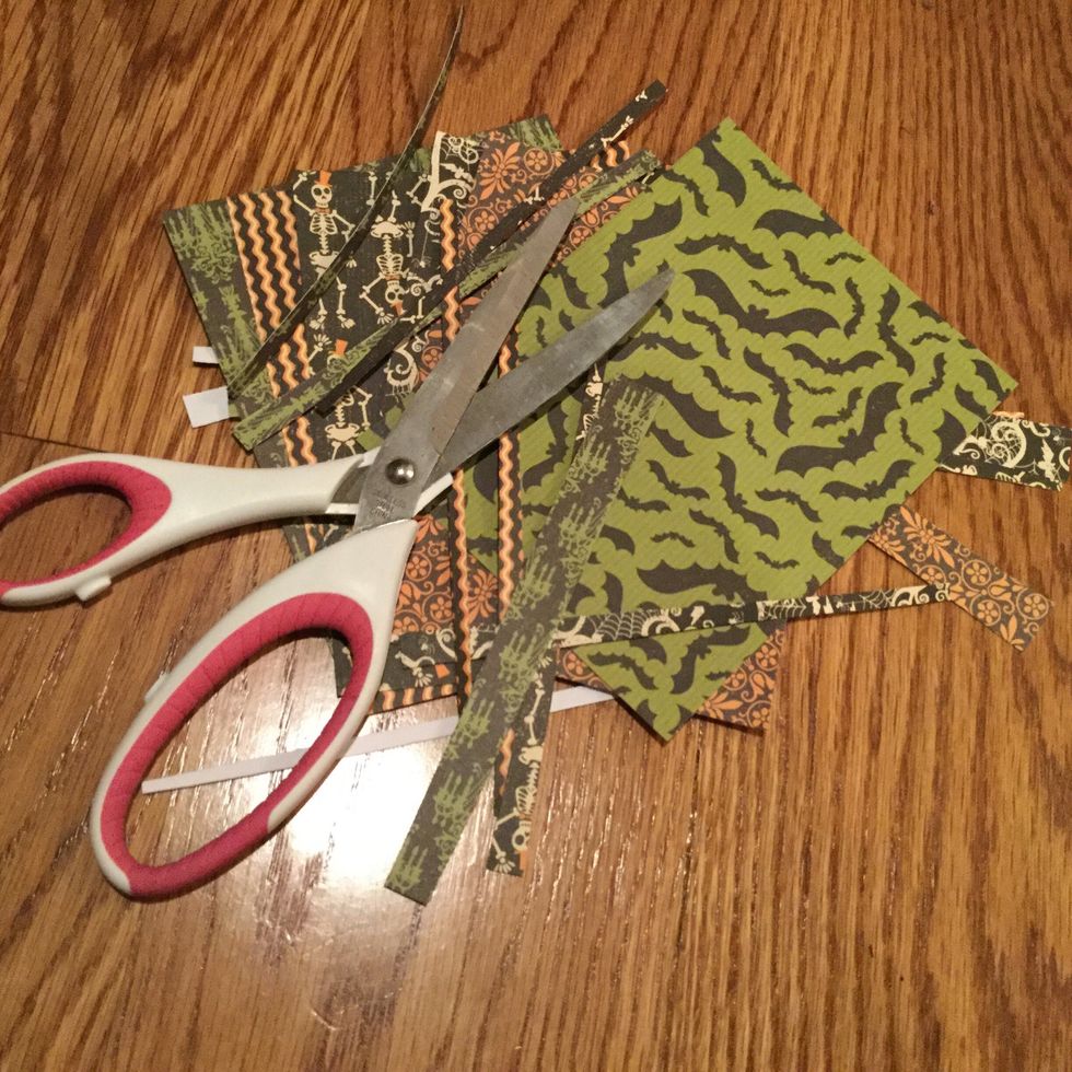 Cut Halloween themed scrapbook paper.