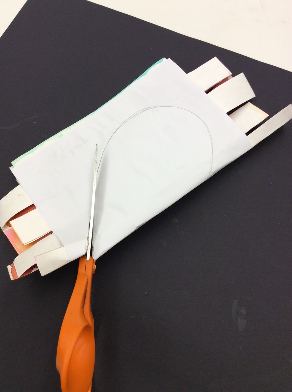 Cut heart out along line while paper is folded.