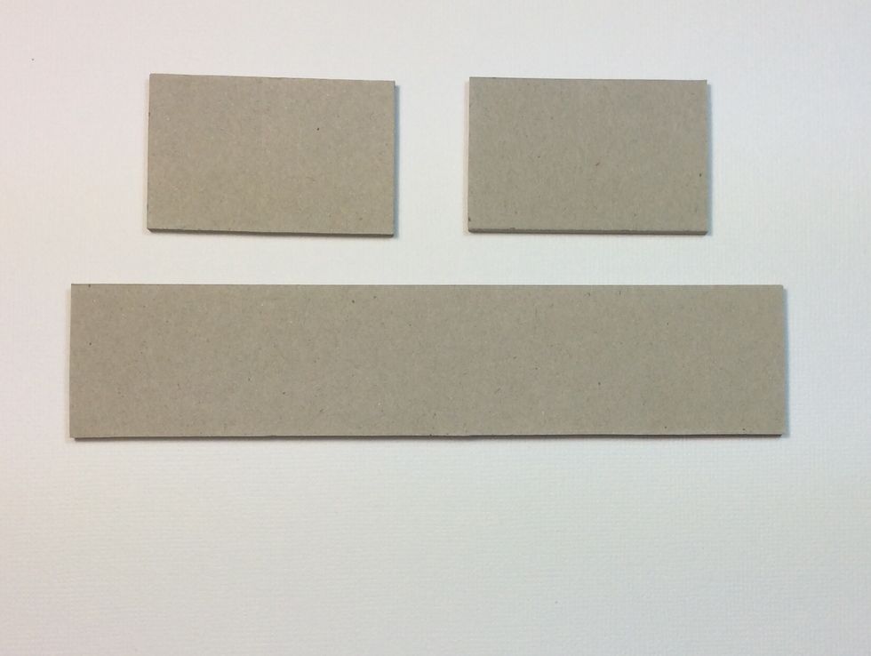 Cut heavy weight chip board, one at 1 3/8 x 6 1/2 inches and two at 1 3/8 x 2 1/4 inches. Some trimming of the length may be necessary due to variations in the box.