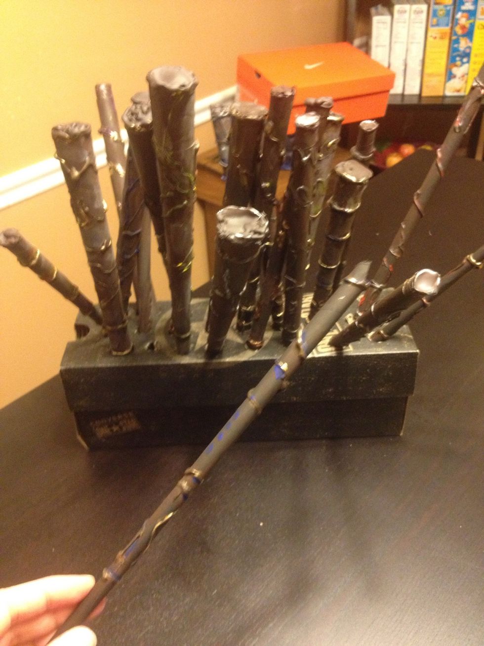 Cut holes in shoe box to let finish drying over night and there you have a wand out of paper