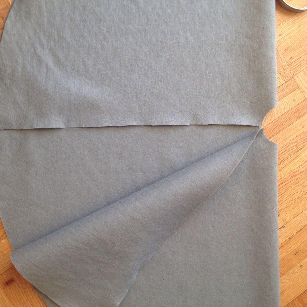 Cut in from the edge to the center  circle. This will make it easier to assemble around the tree.