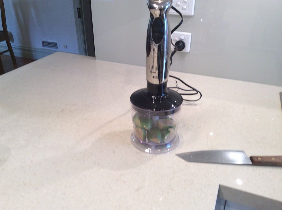 Cut in half and pur\u00e9e the Feijoas with skin. Don't cut your hand! When it is done it should look light green coloured with dark green specks. Put this aside in a separate bowl (not with the cream).