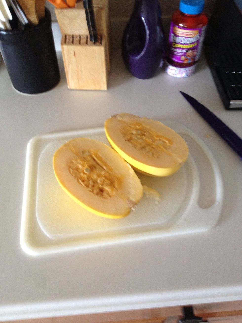 Cut in half. I put a towel down under the squash. It's tuff to cut, so be careful.