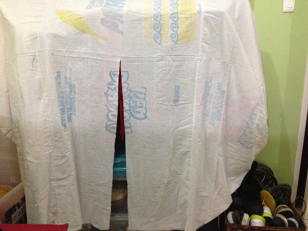 Cut in the middle of the fabric but not all the way through to create two front panels.