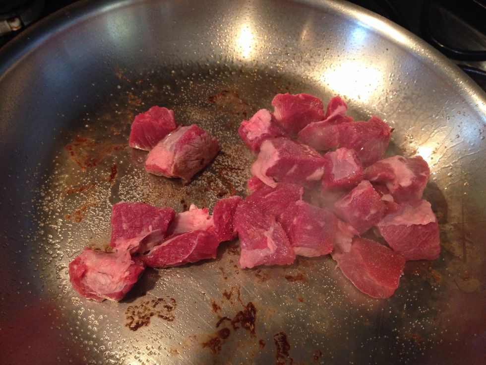 Cut into 1" pieces and brown in batches. Use a little olive oil and salt while browning. Note - cooking too much meat at a time will cause the pan to cool and you'll end up basting vice adding color.