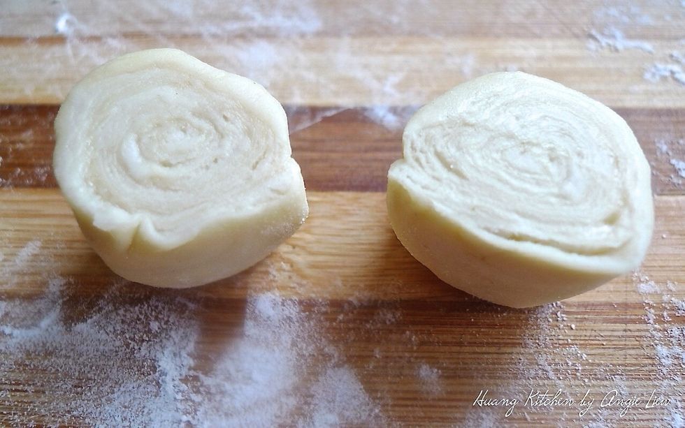 Cut into 2 equal halves. Repeat the same for the rest of the Swiss Roll shape dough. You will have 20 cut portions.