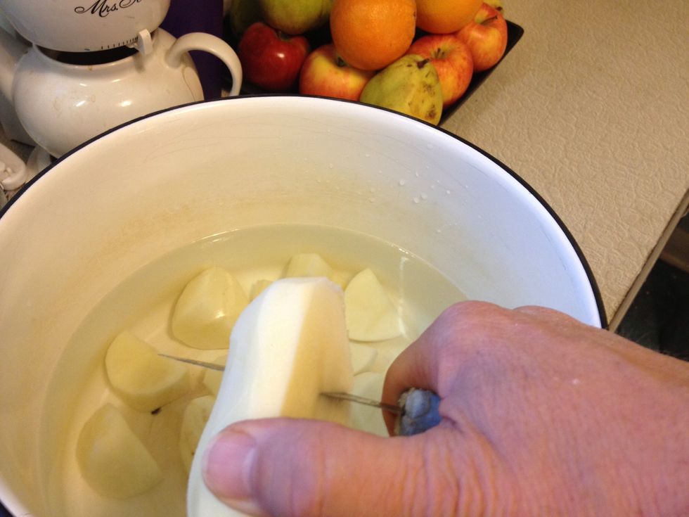 Cut into approximately the same sized pieces directly into a pot of water enough to cover them.