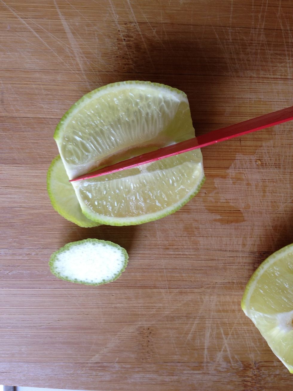 Cut into lime halfway through the "flesh" running the longways . This will allow slices of lime to pinch your glass.