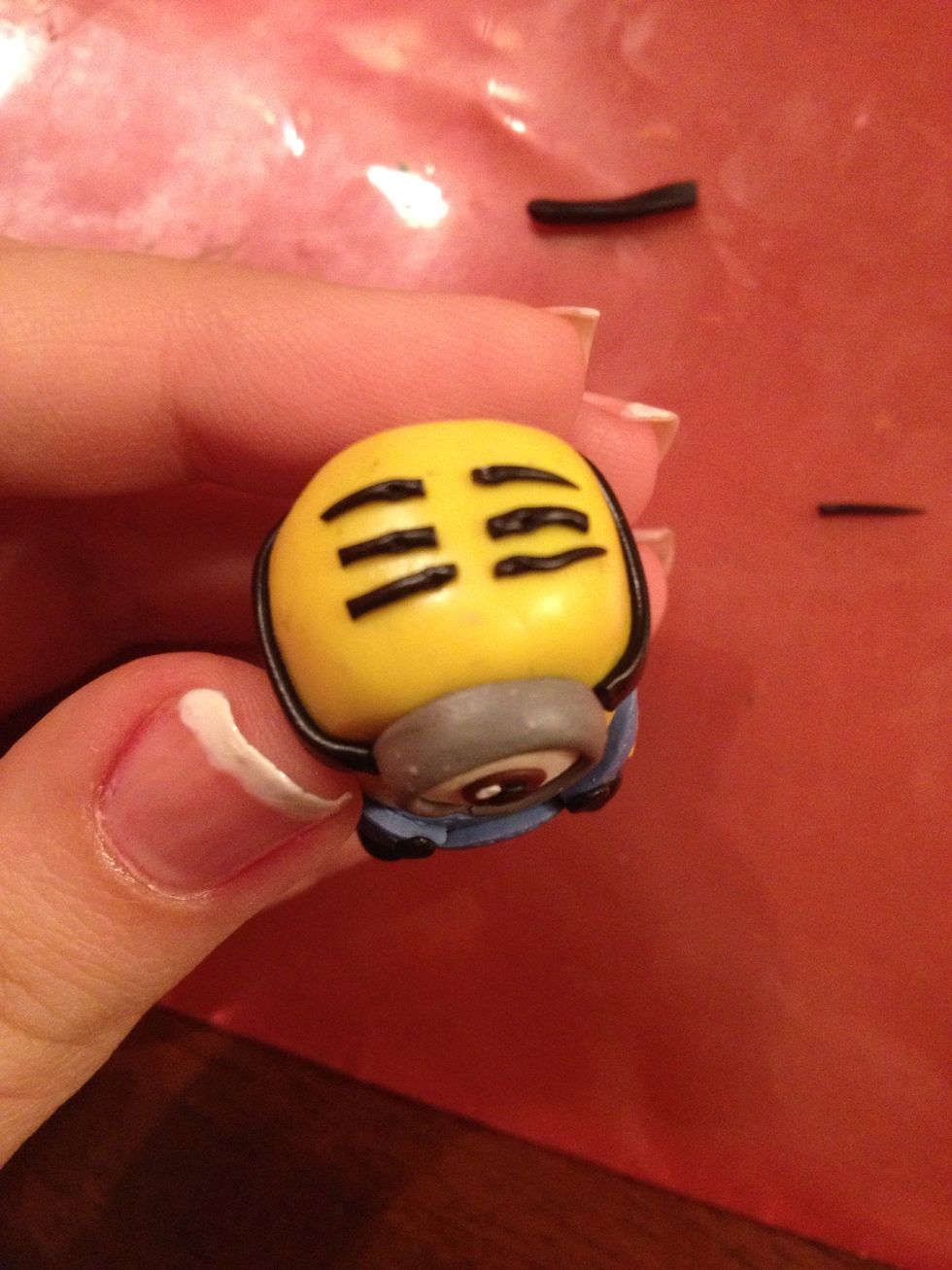 Cut it into short parts and you'll get hair for your minion. Attach it to his head.