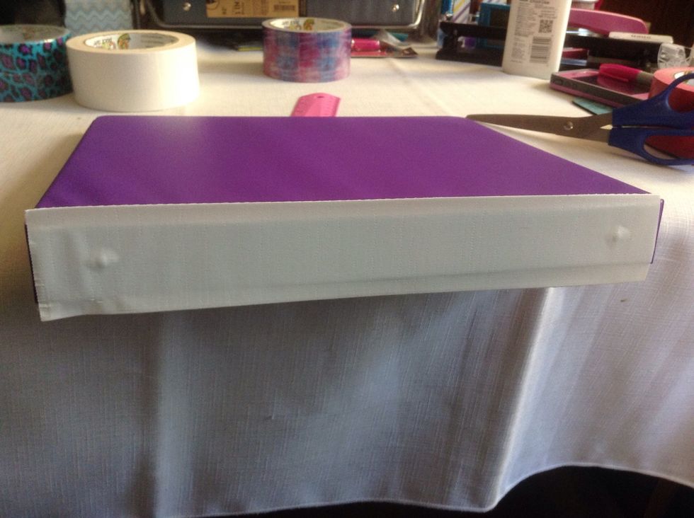 Cut it to the length of the binder and stick. Try to center the tape somewhat. Cover the "posts".