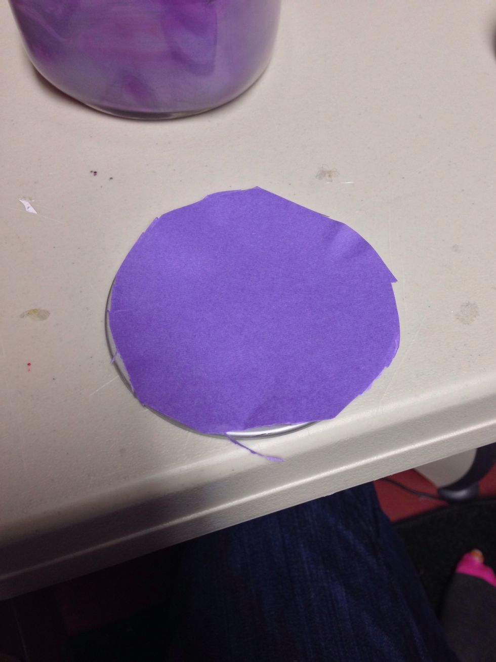 Cut it to the size of the circle part of the cap and hot glue