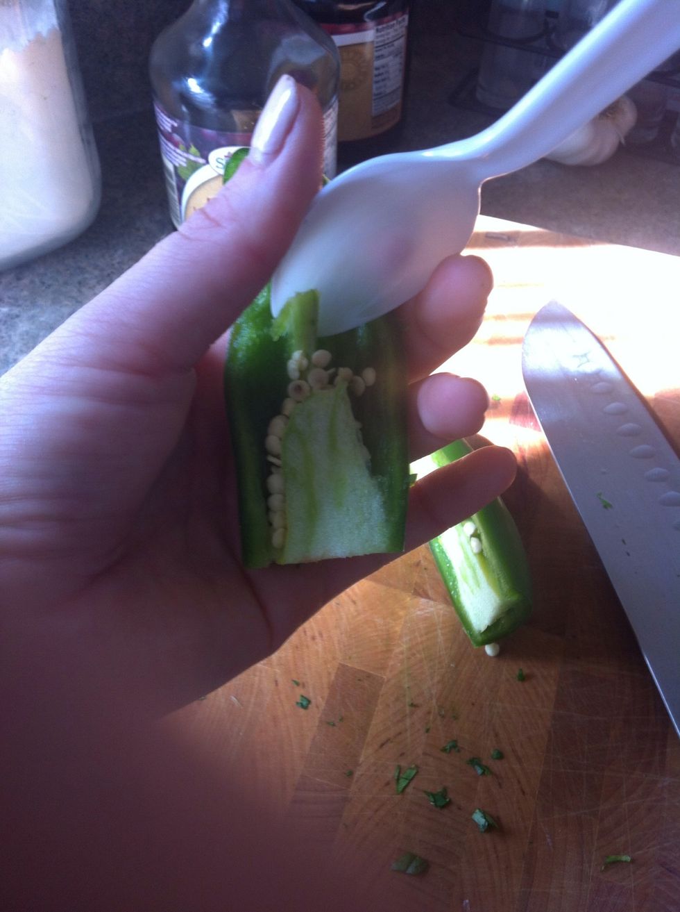 Cut jalape\u00f1os in half and deseed them