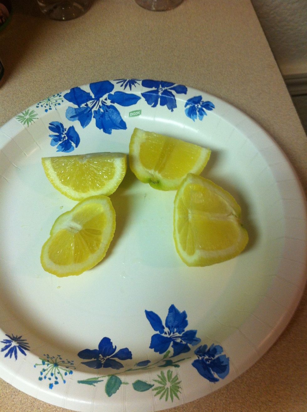 Cut lemon in 1/2. Then each half in 1/2 again. Easy to squeeze when cut this way.