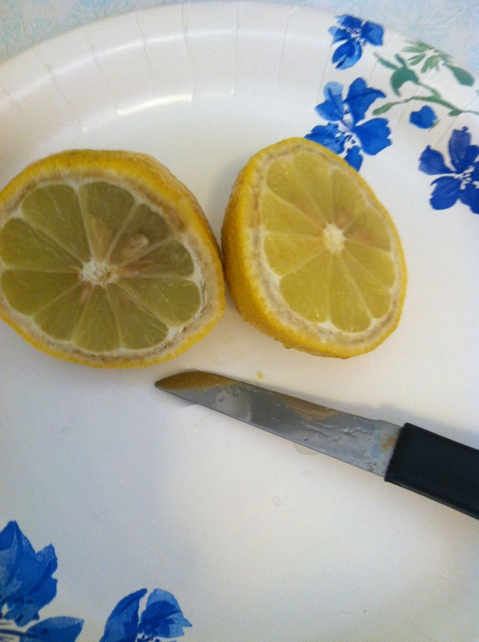 Cut lemon in half. You only need one half so save the other half for later in the fridge.