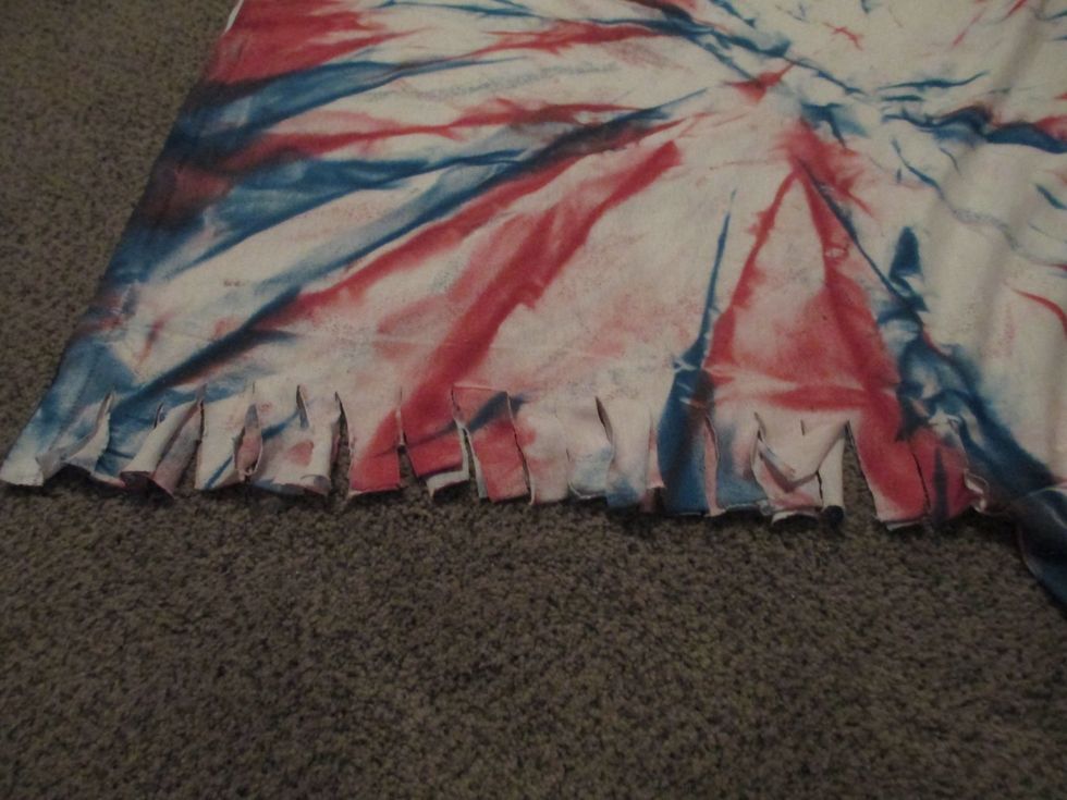 Cut little tabs in the t-shirt 1inch apart. Make the tabs about 1 inch apart.