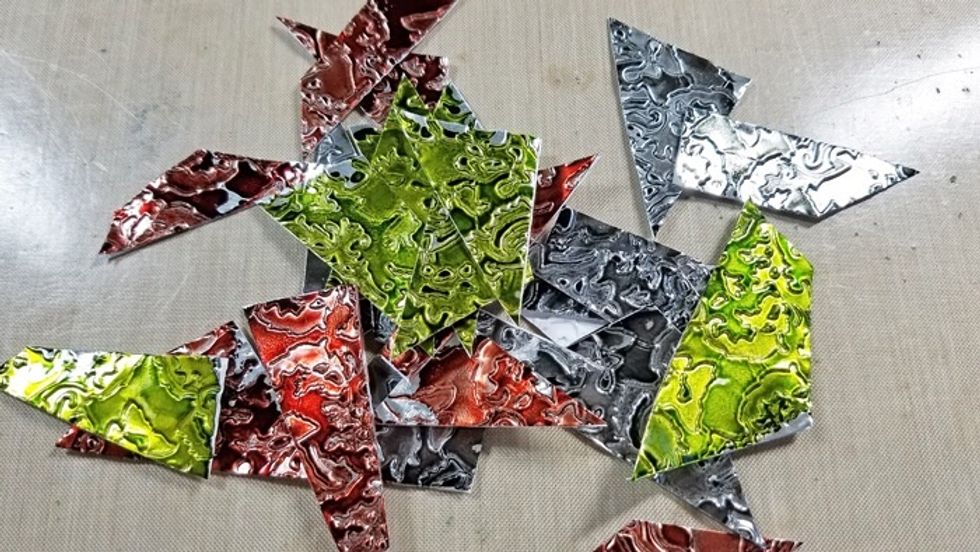 Cut metal sheets into random sized pieces.