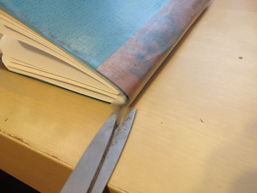 Cut more slits where the other cover meets the spine.  Repeat the trimming and folding over the remaining cover.