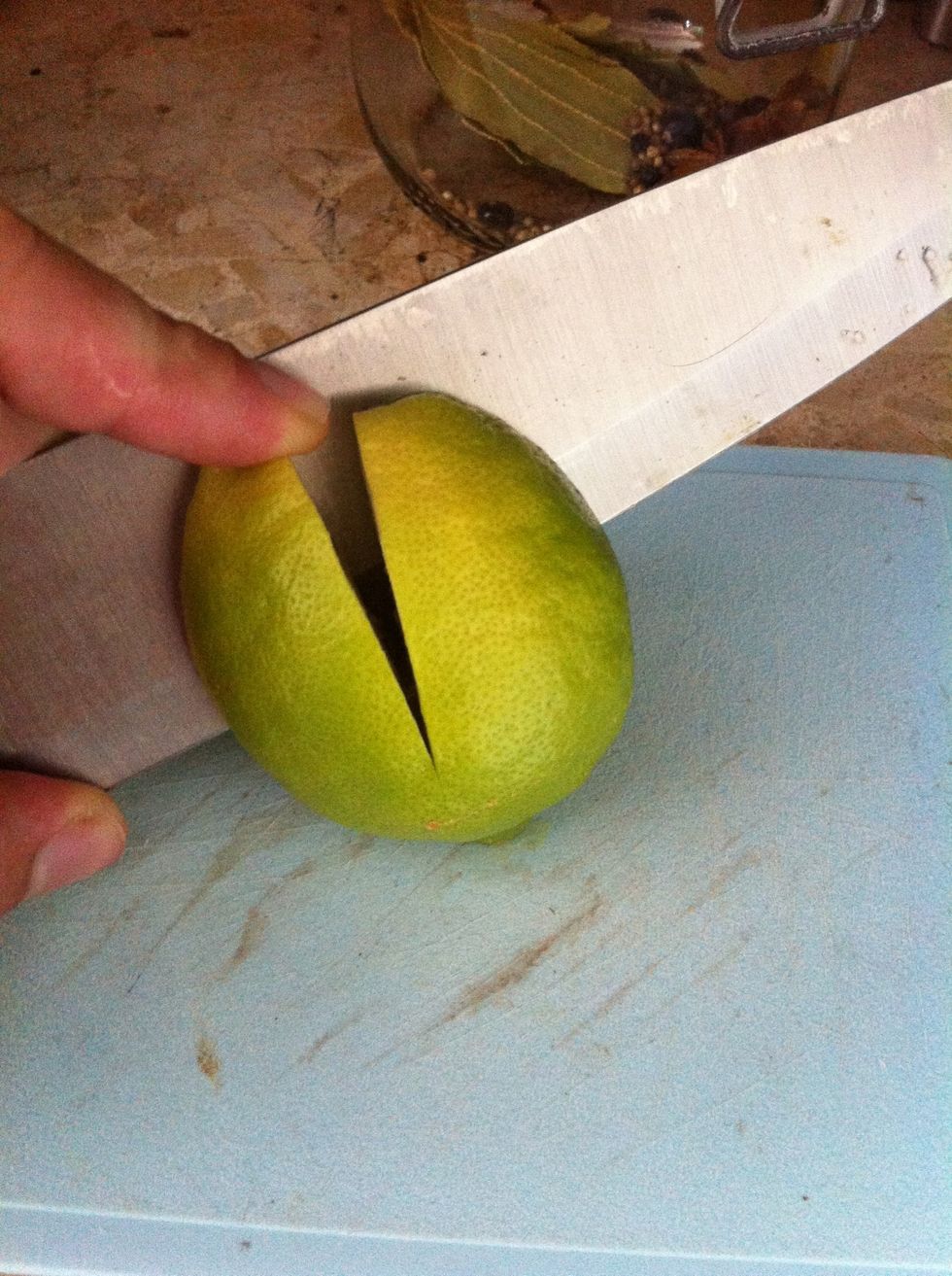 Cut of any stalks of the lemons. Cut 2 incisions into the lemons about 3/4 of the way.