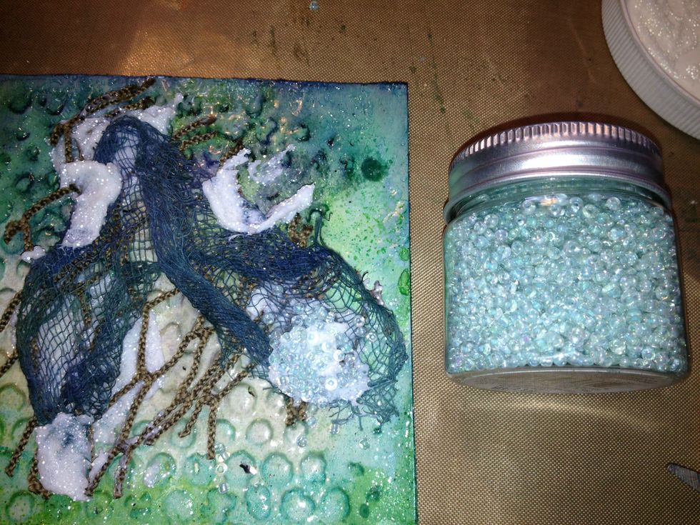 Cut off a piece of your cheesecloth and using gel medium I added that to the card and sprinkled seed beads over the gel medium while still wet.