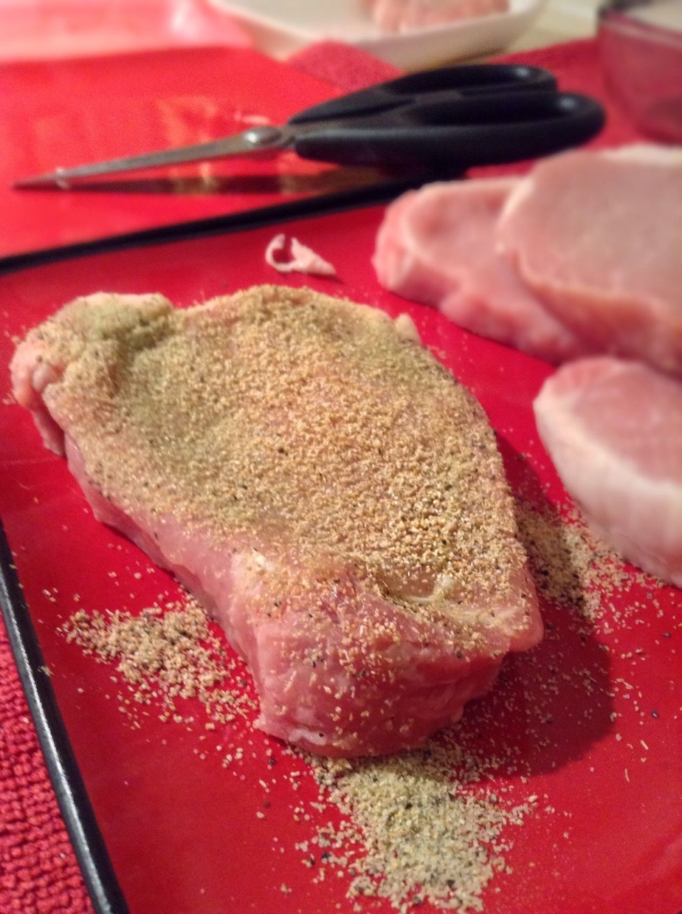 Cut off any major chunks of fat from the pork chop then generously season both sides of it with a combination of the one tablespoon garlic powder and one tablespoon seasoning salt.