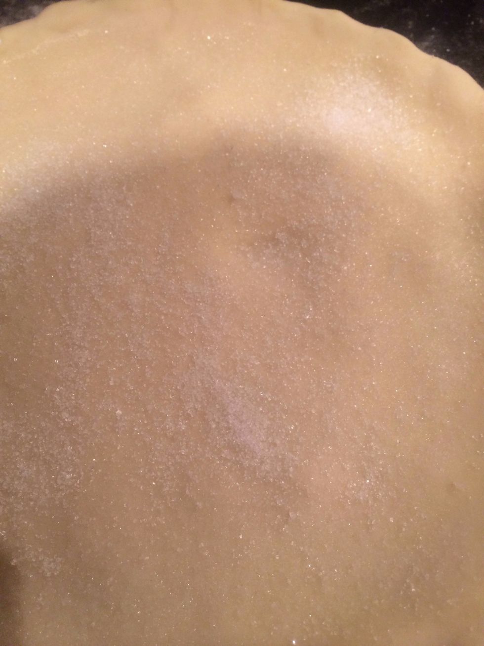 Cut off excess and pinch down edges to make sure they stick together. Brush top with milk and sprinkle with sugar.