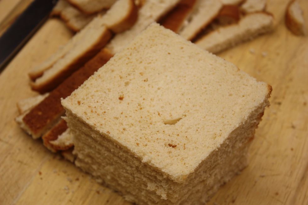 Cut off the crusts of your bread. You can see here that I used a soft wheat bread. Cheap bread is good here and white or wheat doesn't matter.