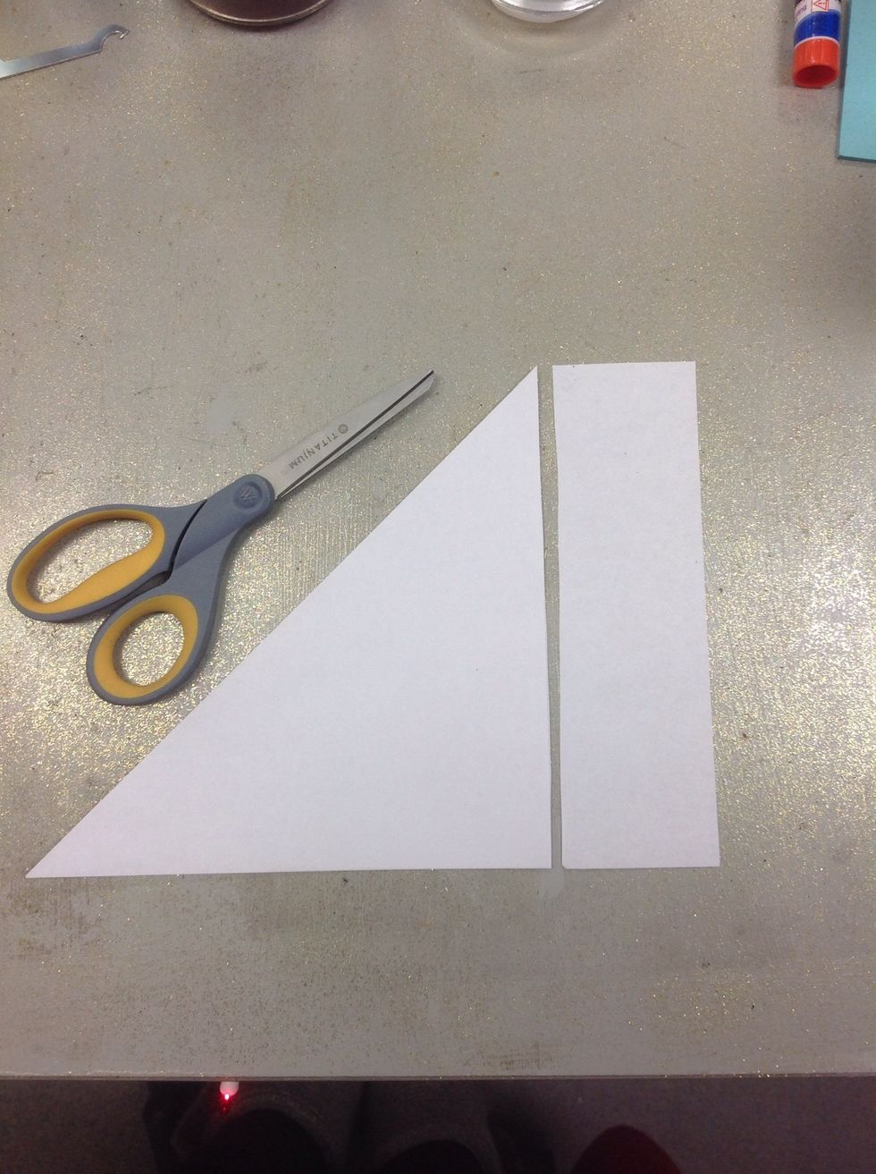 Cut off the extra paper, so that you have just the triangle. (Cut as straight as you can so that the end product will be symmetrical.)