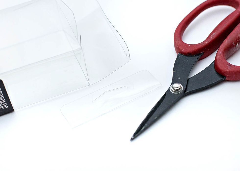 Cut off the hang tab on each clear box.