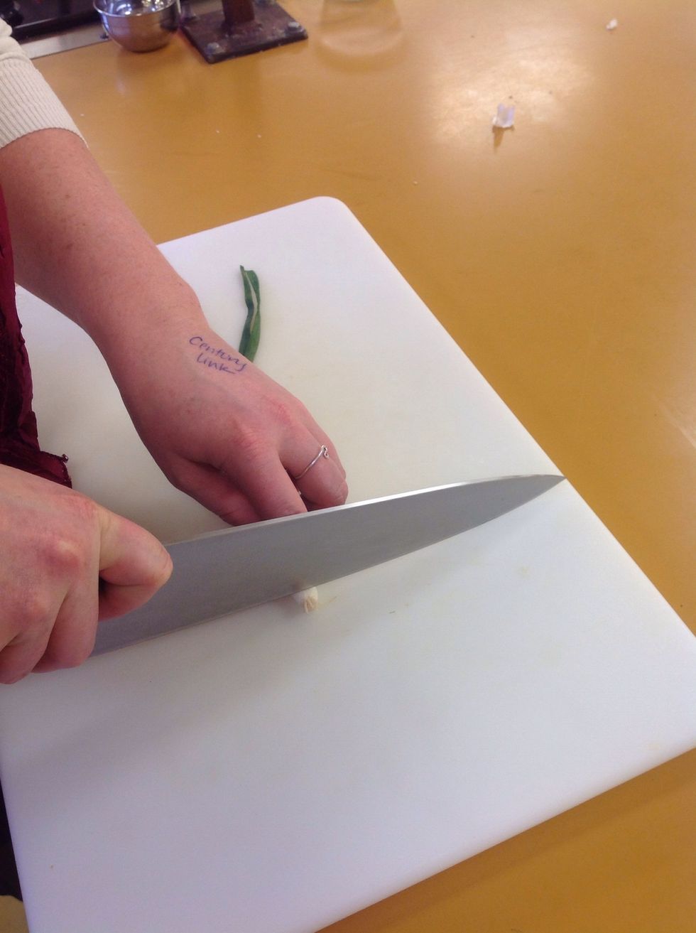 Cut off the root end of the green pepper. Then using the slicing motion cut the whites and the green of the onion. When you are finished all of the onion will be sliced in little rings.