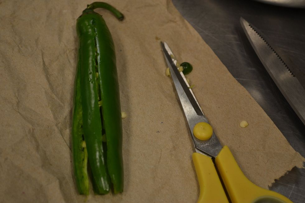 Cut off the tip then snip the chili in 2-4 strips lengthwise