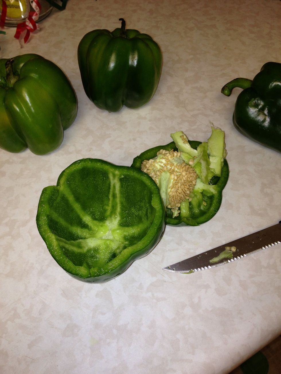 Cut off the top of the peppers and remove the seeds. If necessary cut along the sides to remove the excess white but be careful not to cut the bottom.