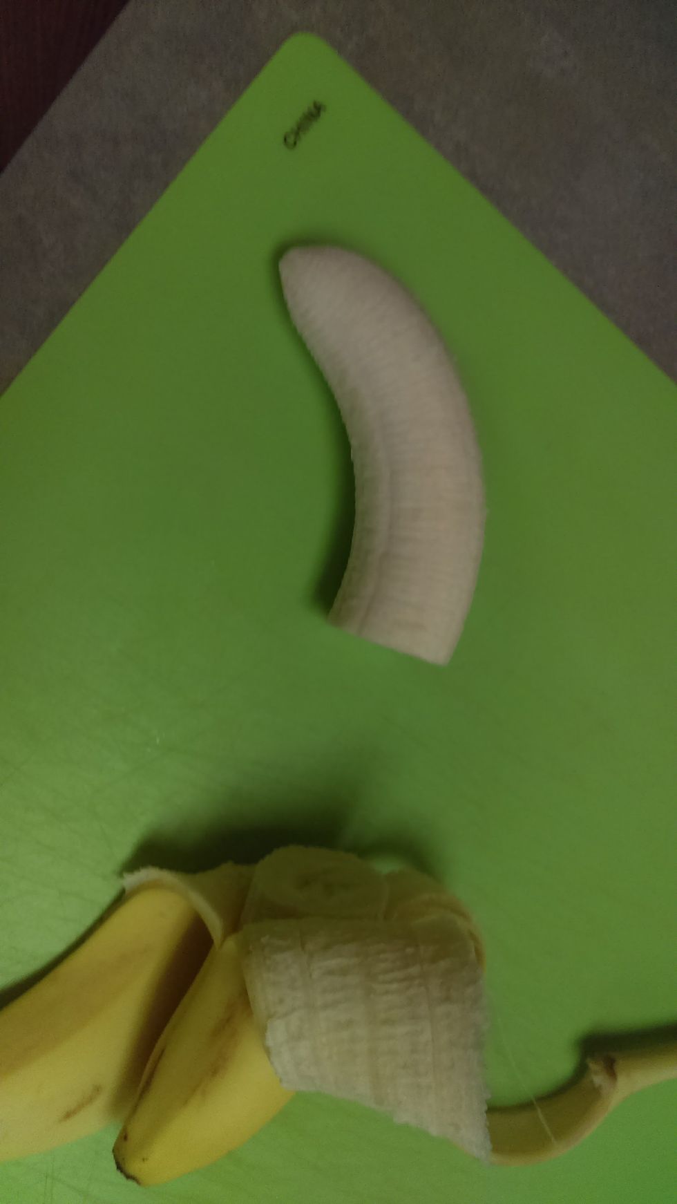 Cut off the unpeeled part of the banana.