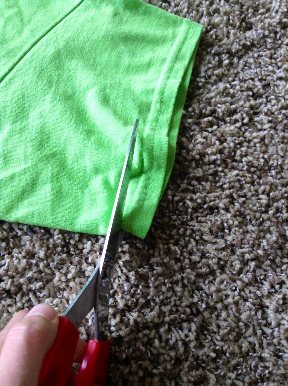 Cut on the hem, as close to it without wrecking it.