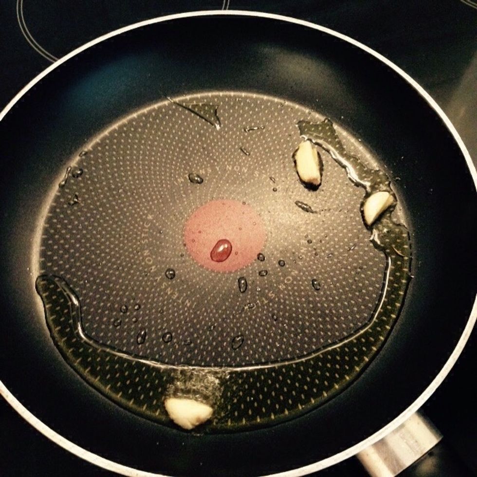 Cut one garlic clove and add it to a pan with some olive oil