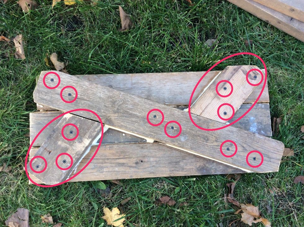 Cut one piece of wood into the two pieces of wood that are circled, then screw in screws in the places that the screws are circled.