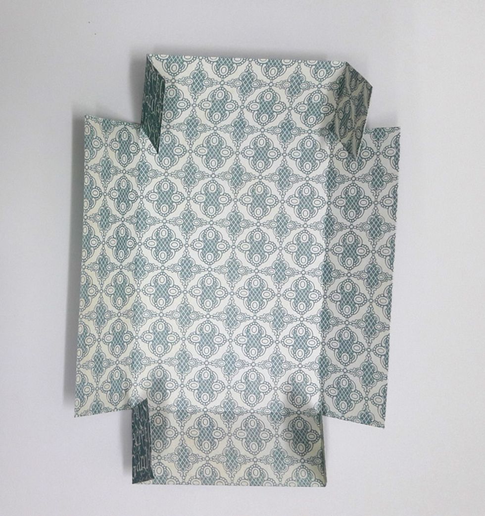 Cut one side of corners up to fold line.