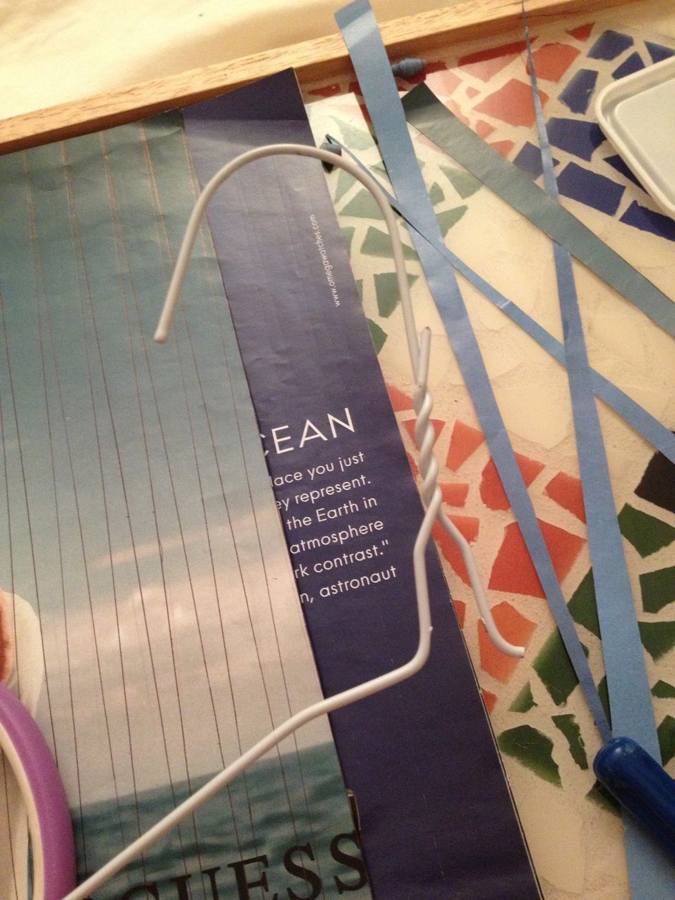 Cut one side of the hanger and straighten it out.