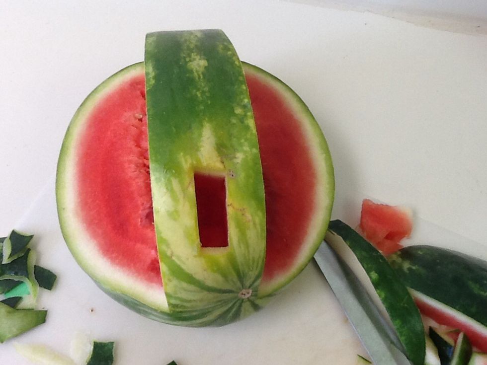 Cut open a small hole towards the front, just big enough to fit the bottom of the swan in. Note that it is better for the hole to be too small than it be too big.