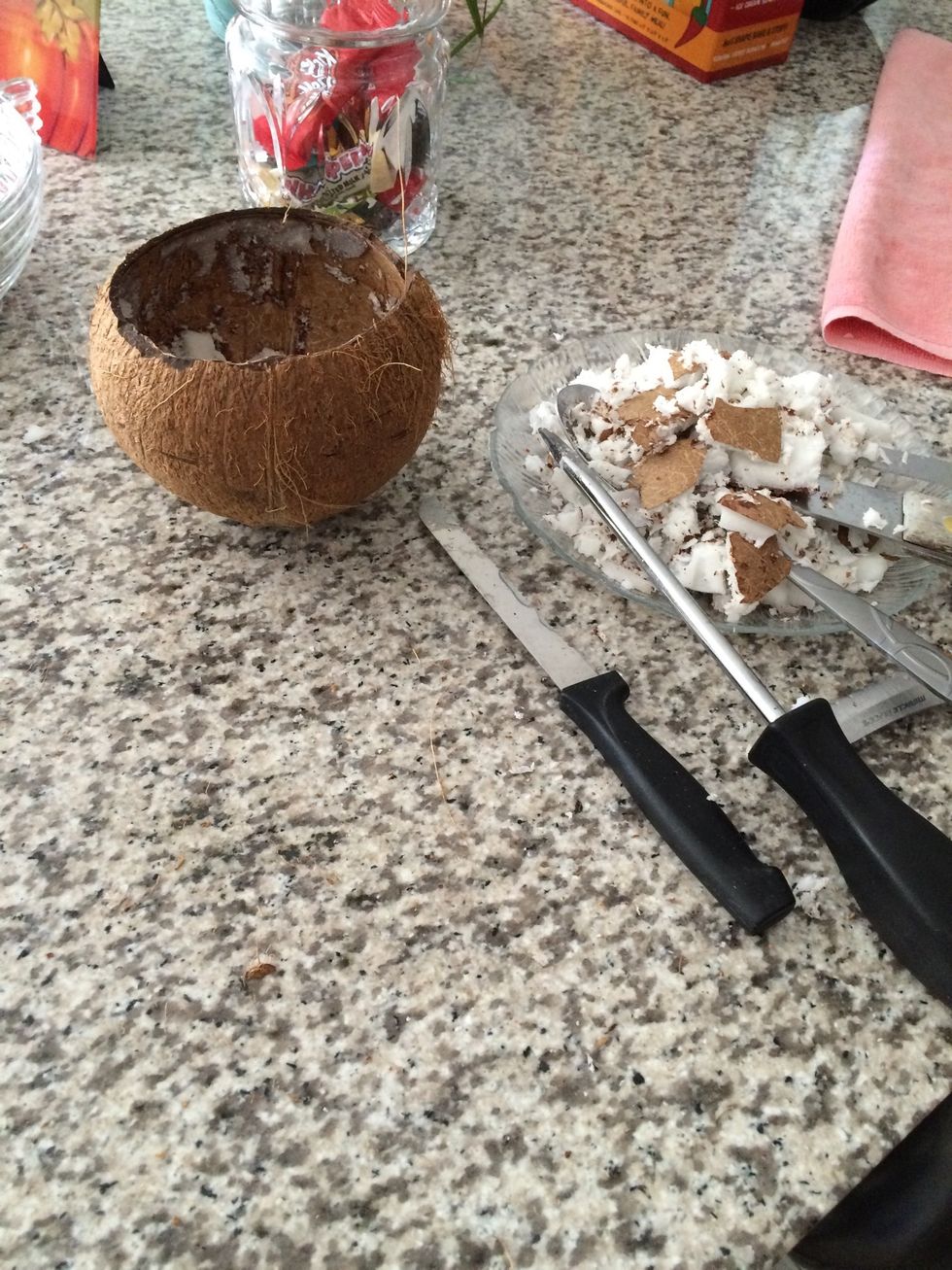 Cut open coconut at the top and scrape out the meat